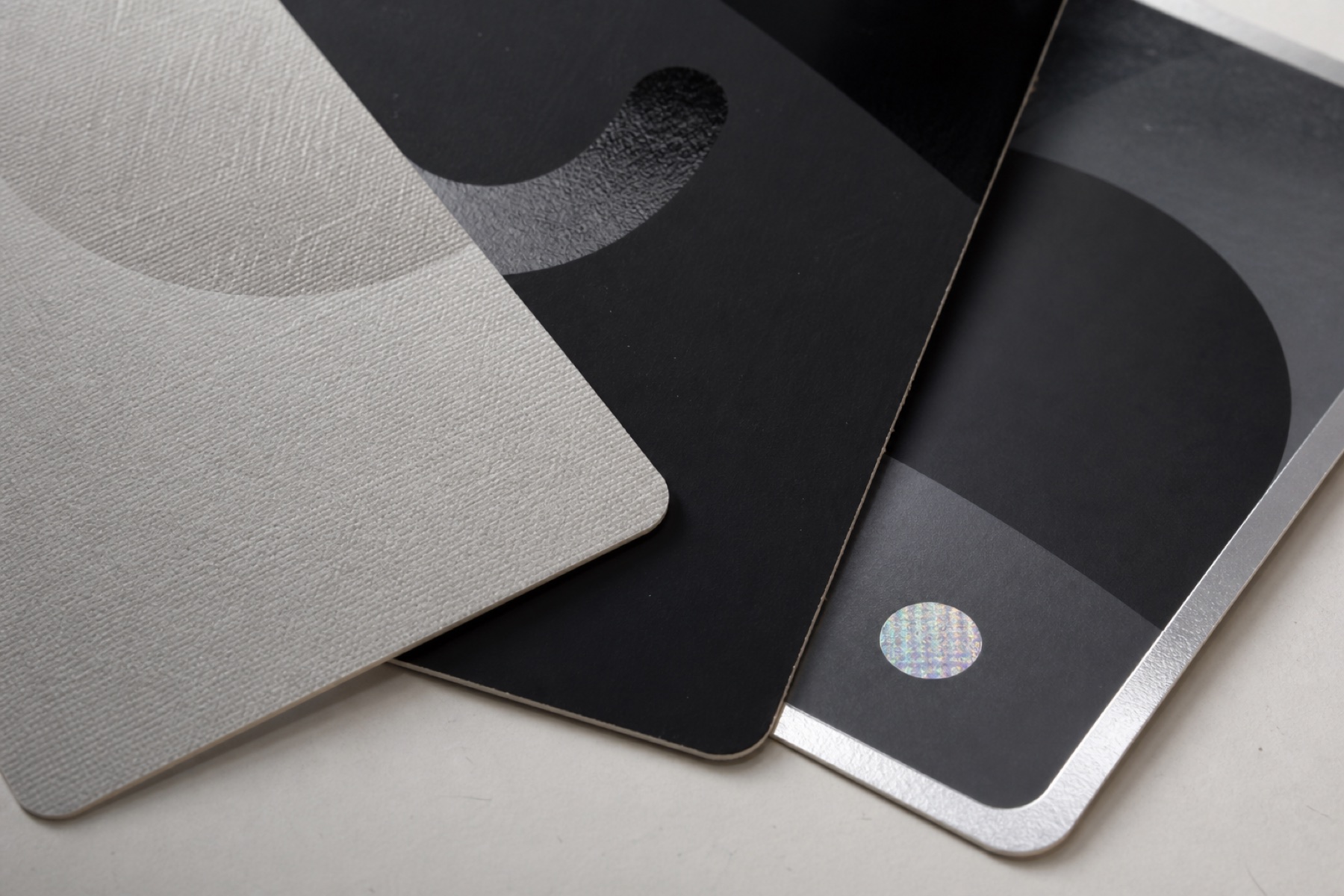 TCG Card Finishes Guide: Foil, Holographic and Collector Card Printing Close-up comparison of linen texture, spot UV, silver foil and holographic card finishes